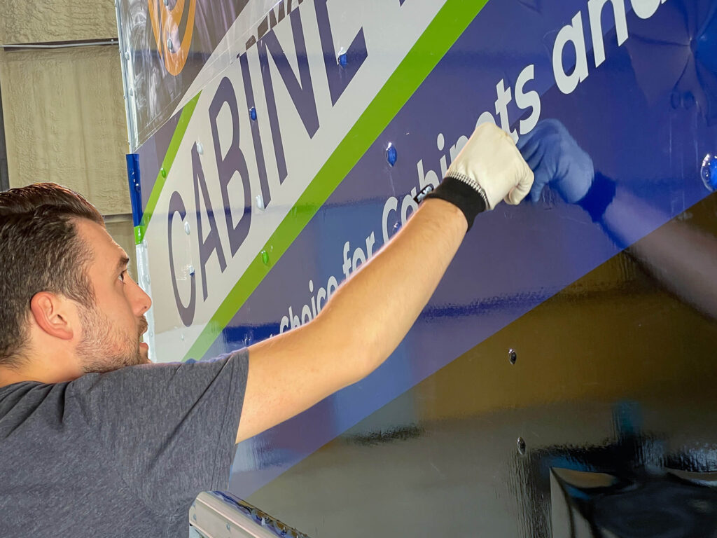 Wrap Genius technician applying vehicle wrap.