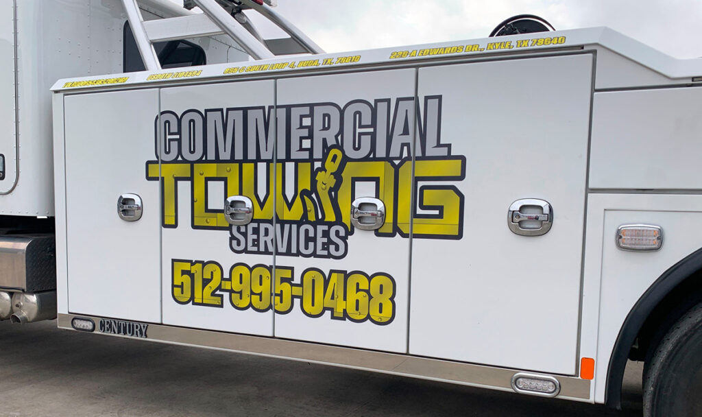 A white vehicle with a grey and yellow vehicle wrap in Austin.